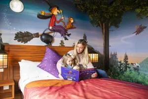 Mother and Daughter reading a book in the Room on the Broom Room at Chessington World of Adventures Resort