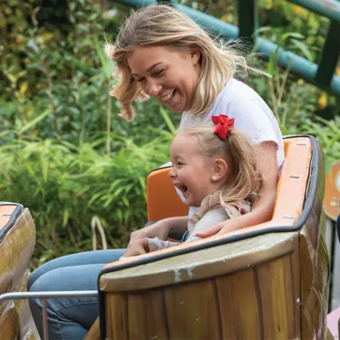 Adult and child on Griffin's Galleon ride at Chessington World of Adventures Resort