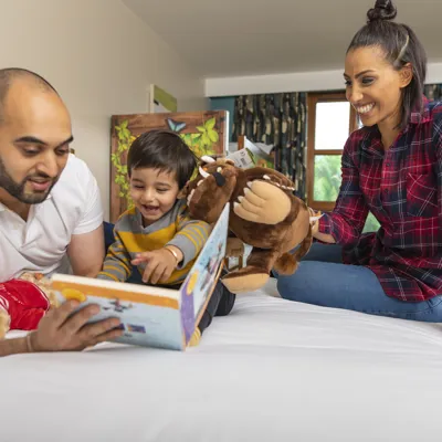 Family reading book with Gruffalo toy